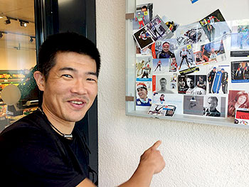 [写真]飾ってある写真とそれを指さす新田選手