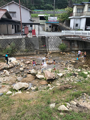 [写真]家の目の前で水遊びする子供たち